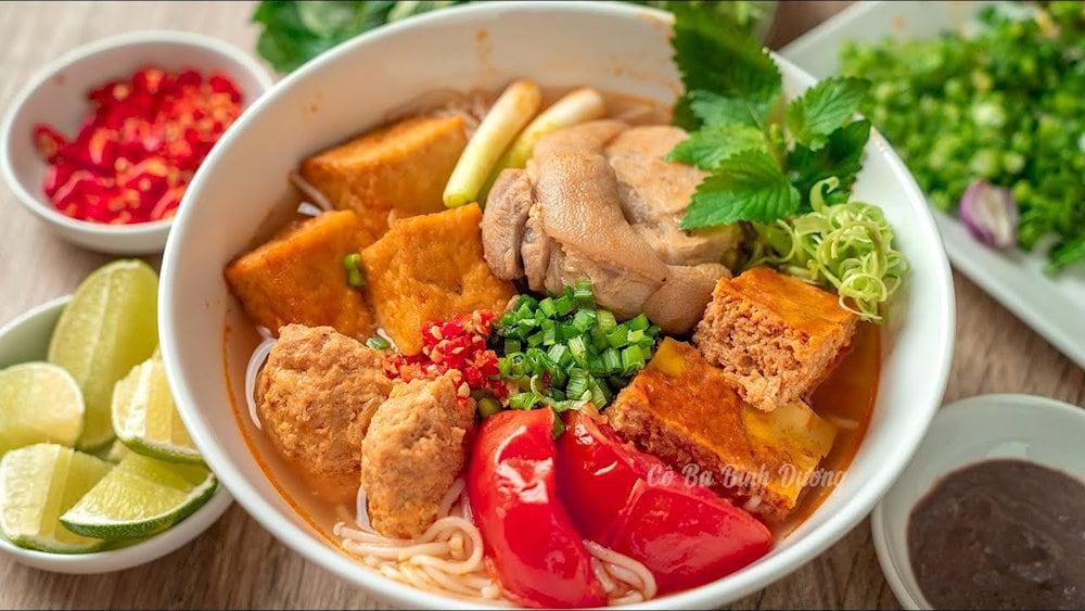 A steaming bowl of Bun Rieu with a variety of flavors
